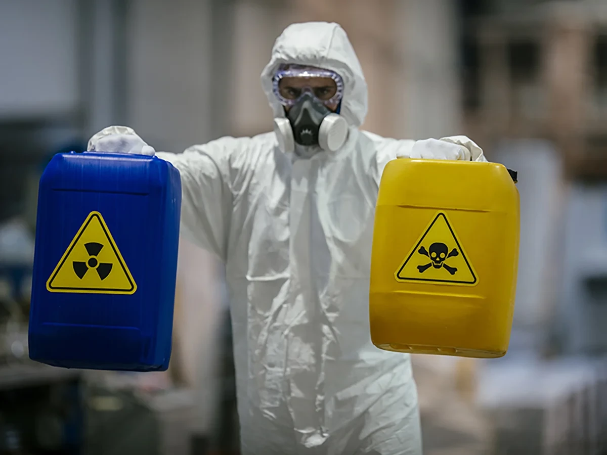 Biohazard cleanup technicians in protective equipment at a remediation scene in Fayetteville, AR
